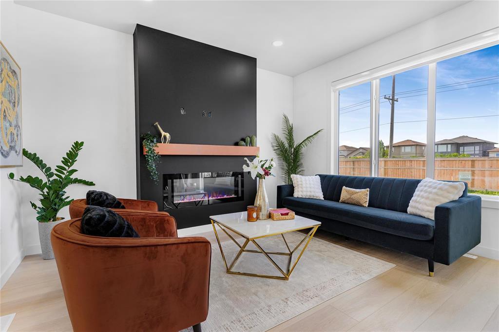 Living room with electric fireplace and large window